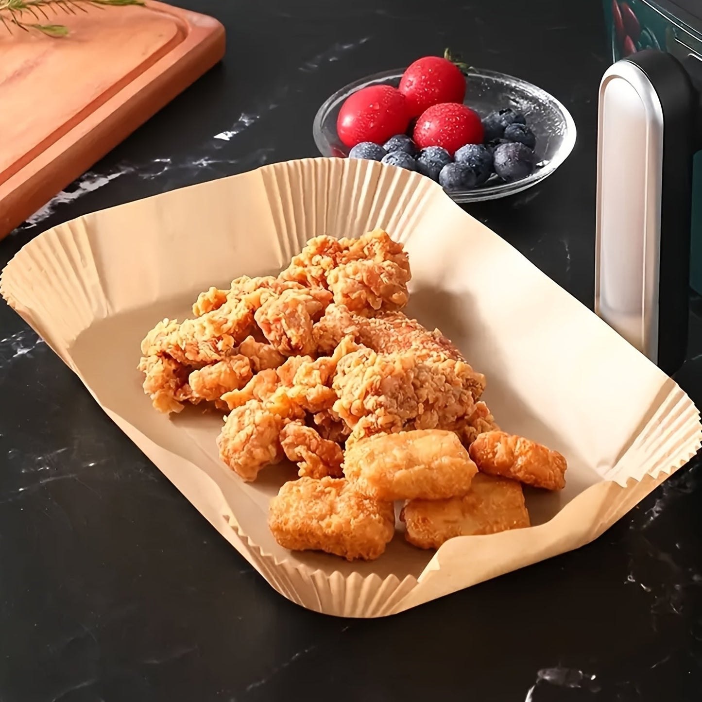 A set of 100 Non-Stick Disposable Air Fryer Liners made from oil-resistant parchment paper. These trays are oven safe and are kitchen accessories that provide chemical-free cooking supplies.