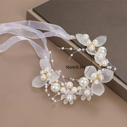 Romantic bridal headpiece with faux pearls, floral wreath, and ribbon tie.