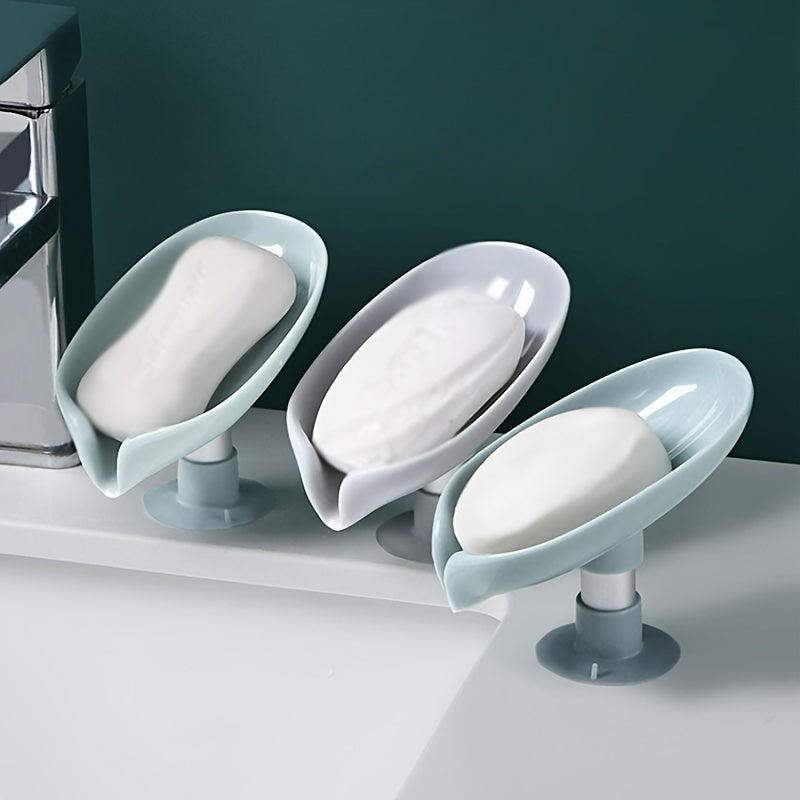 Suction cup soap dish with drainage for home organization and storage, suitable for kitchen and bathroom use.