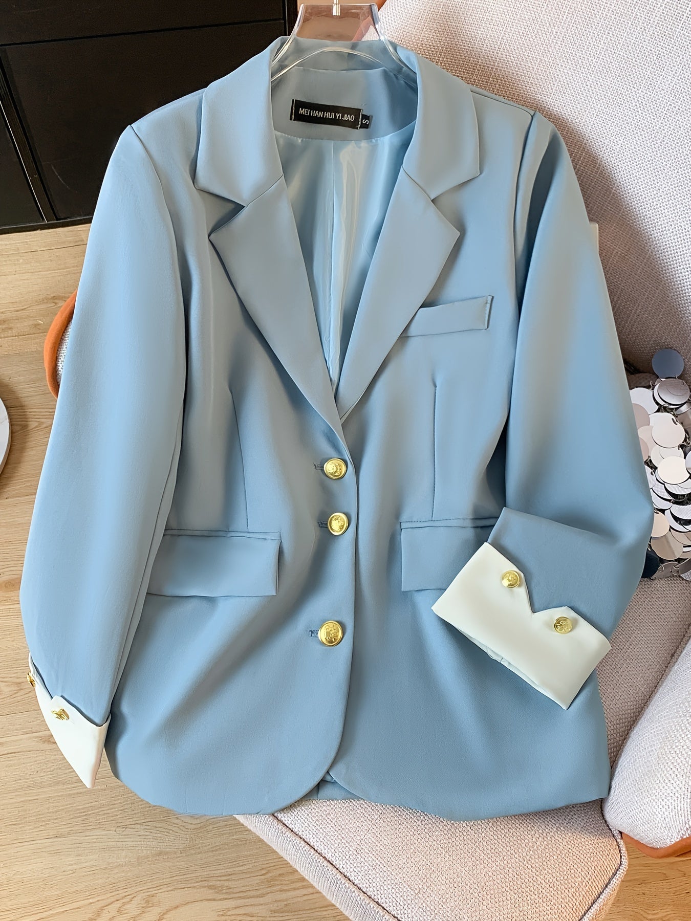 Stylish light blue blazer with golden button details for women, ideal for work in spring and fall.