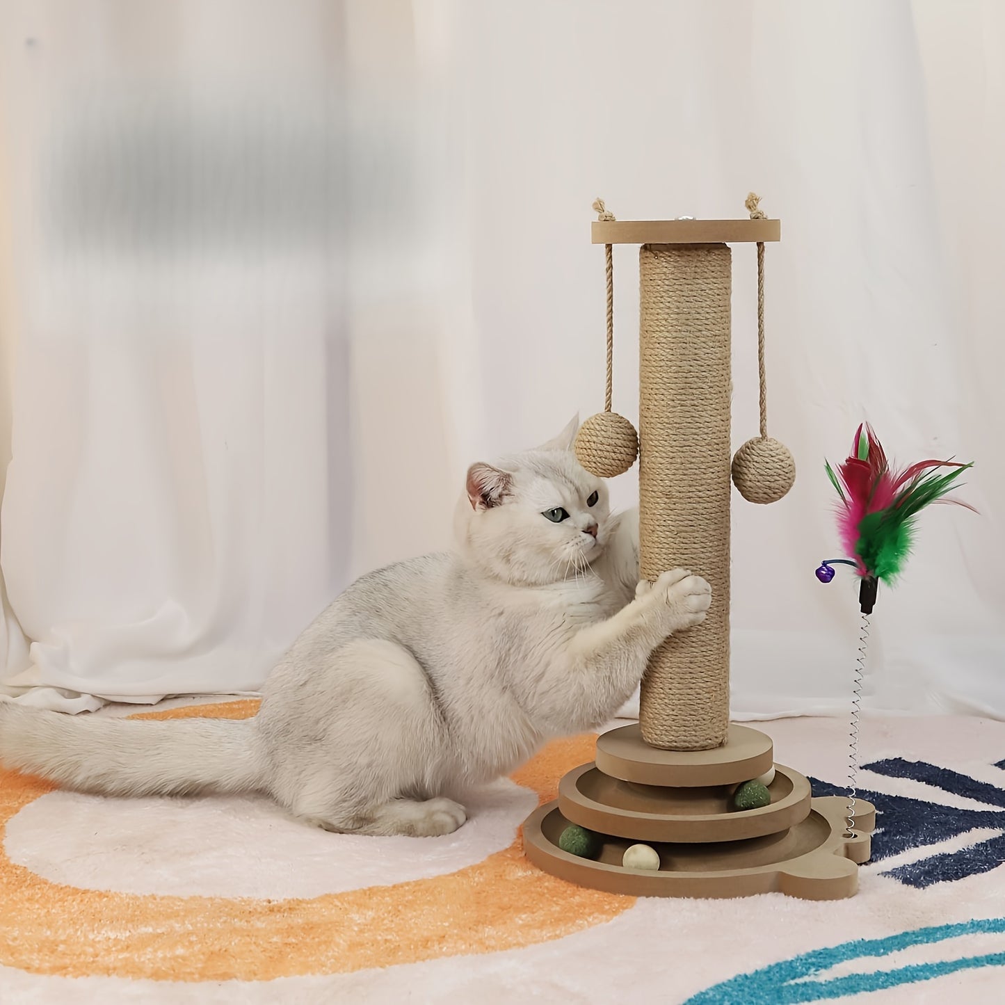 Sisal scratching post with rotating base and play balls for cats' claw care.