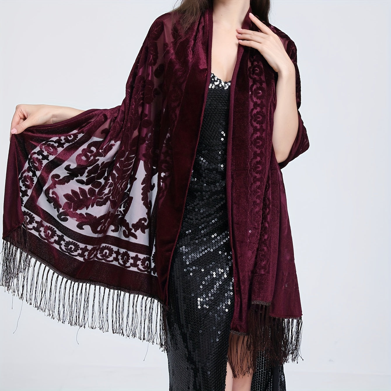 Black floral lace shawl with tassels featuring an elegant rose pattern, 3D carved design, and made of hand washable polyester. Perfect for evening events and dates.