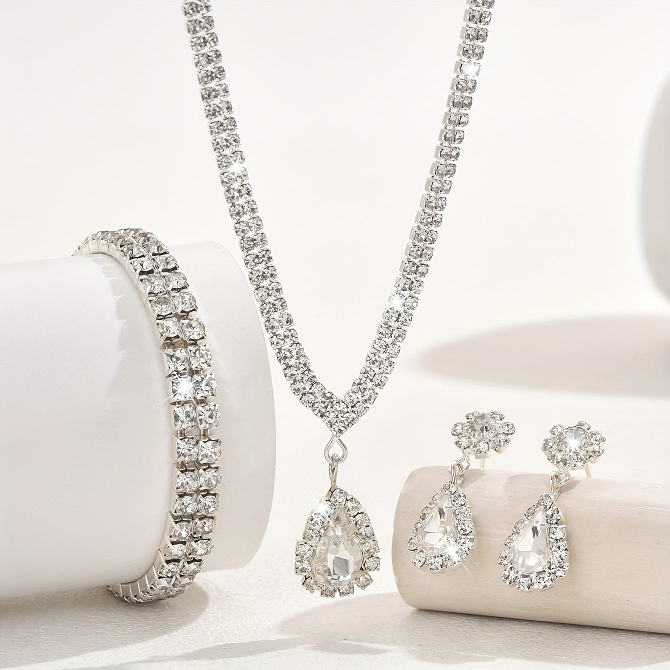 This exquisite collection features luxurious women's jewelry adorned with shimmering water diamonds, including a stunning necklace, elegant earrings, and a versatile stretch bracelet. Perfect for adding a touch of glamour to any party or dance.