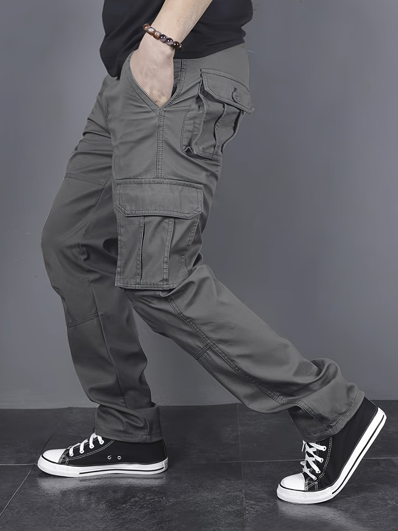 Solid color cargo pants with multiple flap pockets and a drawstring waistband, perfect for outdoor activities like hiking, fishing, and camping.