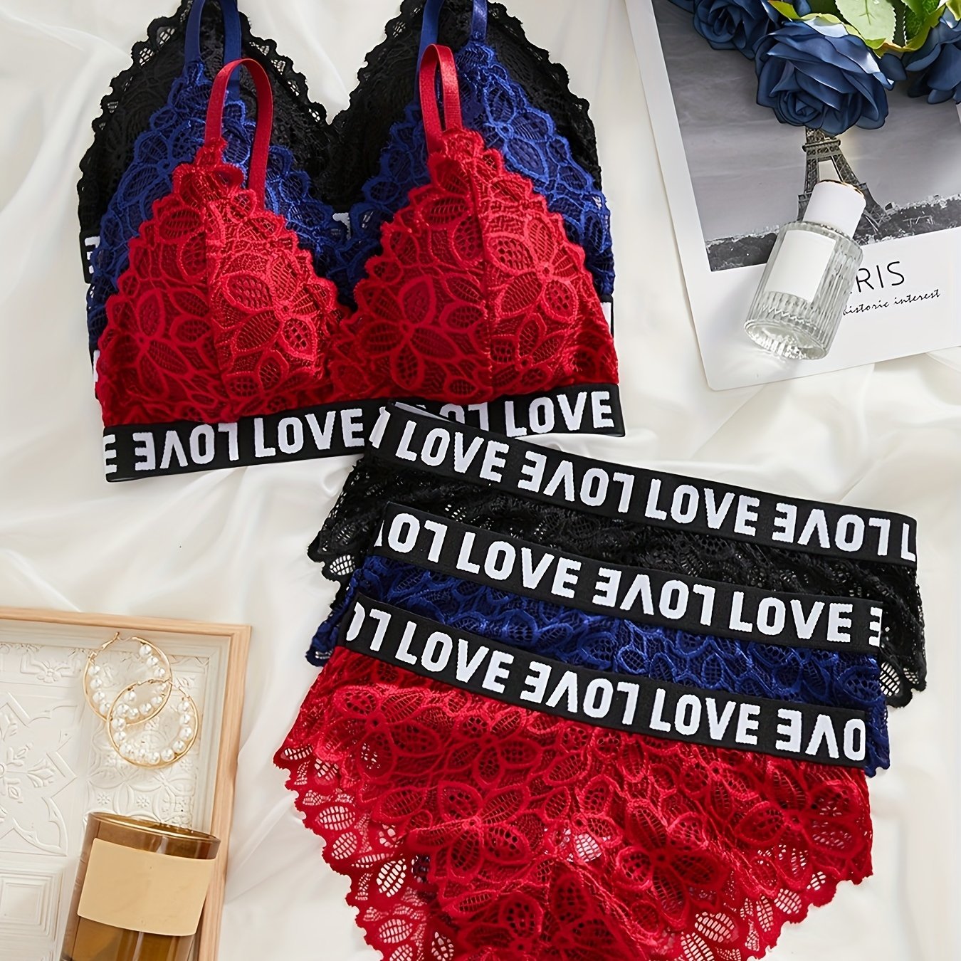 Three sets of lingerie with colorblock letter tape design, floral lace detail, and matching bra and panties for women.