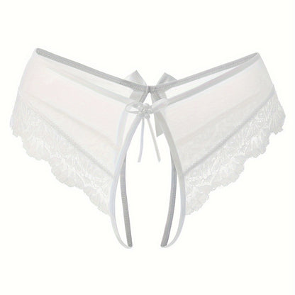 Transparent lace thong briefs with open crotch, low-rise design. Made of 90% polyamide and 10% elastane knit fabric, weighing 111 gsm.