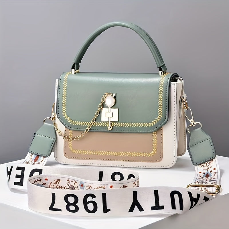 Stylish two-tone women's handbag with adjustable printed strap, made of PU material.