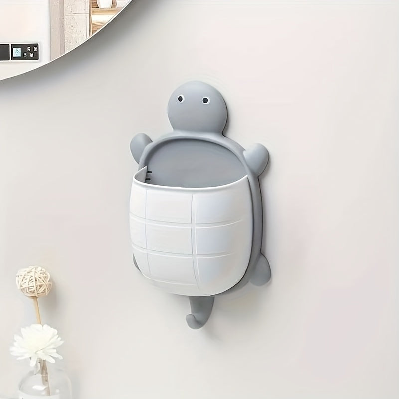 Turtle-shaped wall-mounted remote control holder with self-adhesive storage for home bathroom makeup organization.