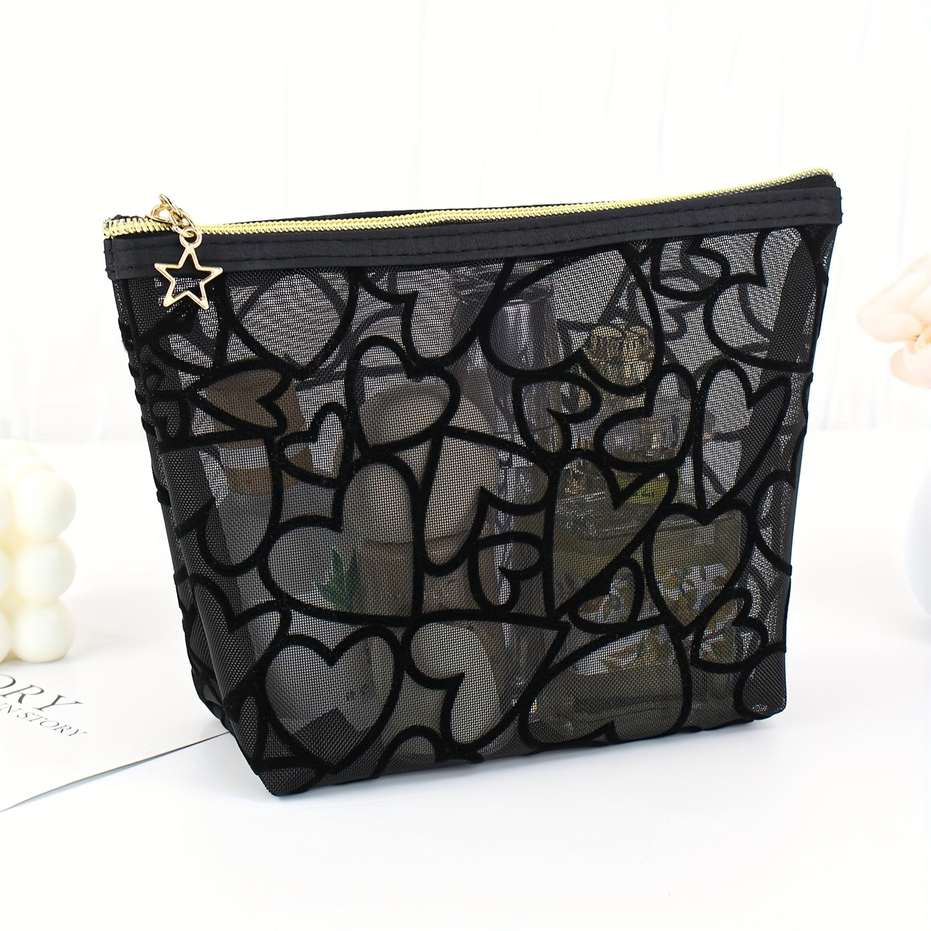 Black waterproof mesh makeup bag with a large capacity, zipper closure, and portable design for travel and toiletries.