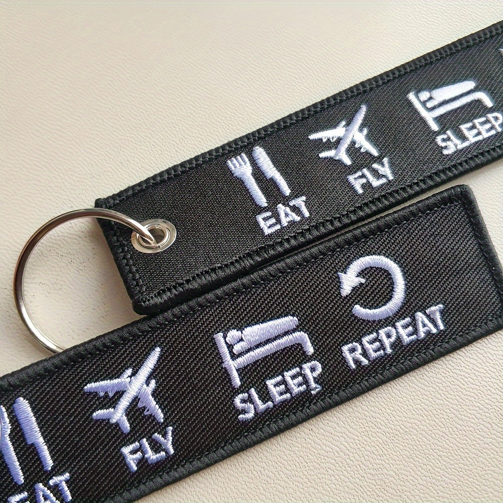 Set of three 'Eat Fly Sleep Repeat' keychains with embroidered design. Ideal gift for pilots, aviation enthusiasts, or anyone with a sense of humor. Keychains come in black and white color combination.