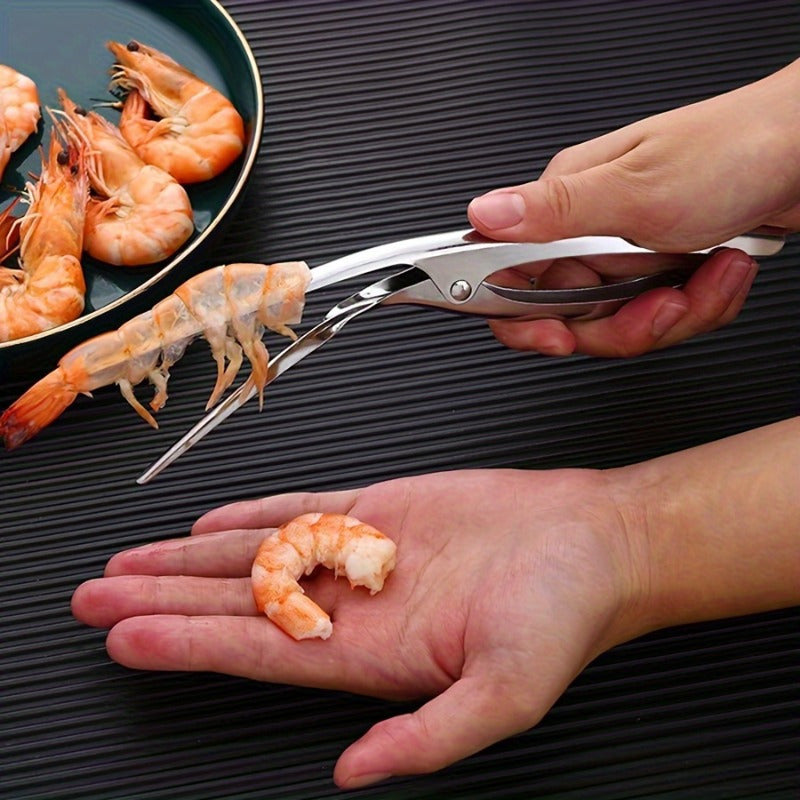 Effortlessly remove shrimp shells with this stainless steel deveiner peeler featuring a comfort grip handle. This kitchen utensil is designed for easy shrimp preparation and is made with food contact safe material.