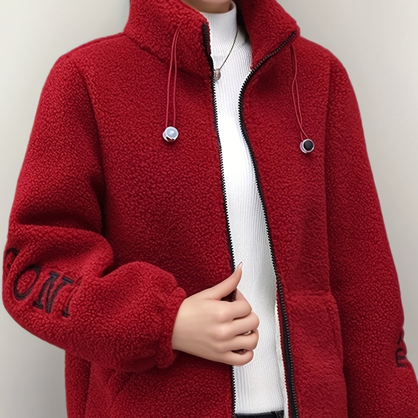 Cozy fleece-like jacket for women with embroidered letters in warm red velvet, perfect for all seasons. Cute and casual with a stand collar, long sleeves, and fleecelike texture.