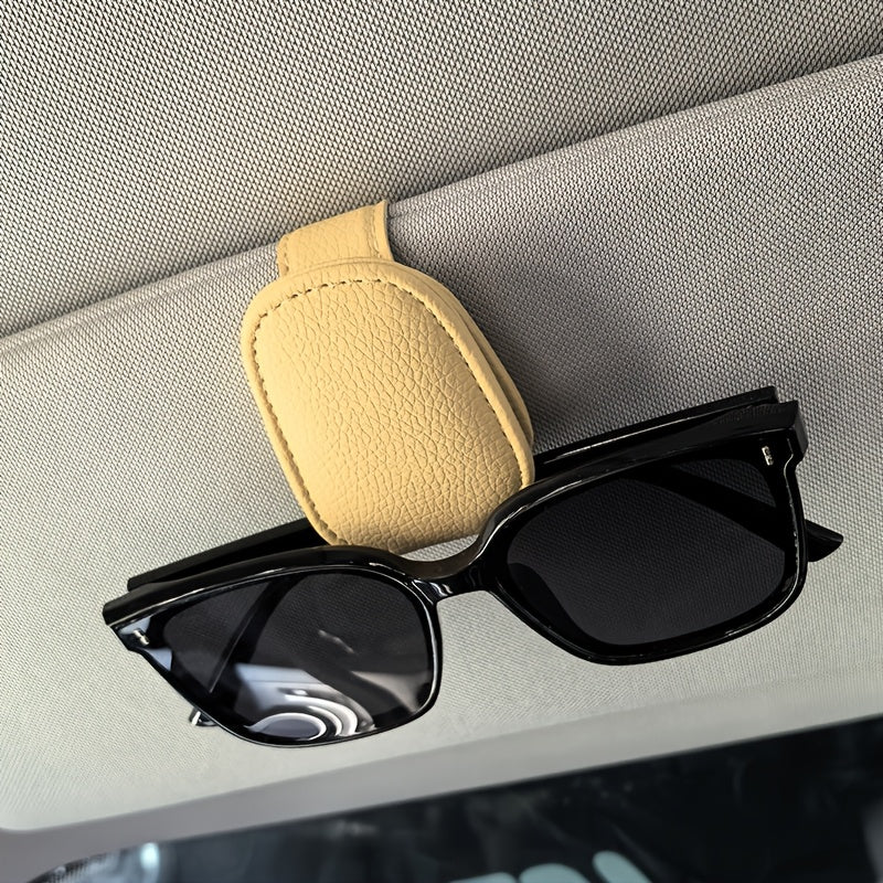 Universal car sun visor clip made of PVC material for storing eyeglasses in the vehicle interior.