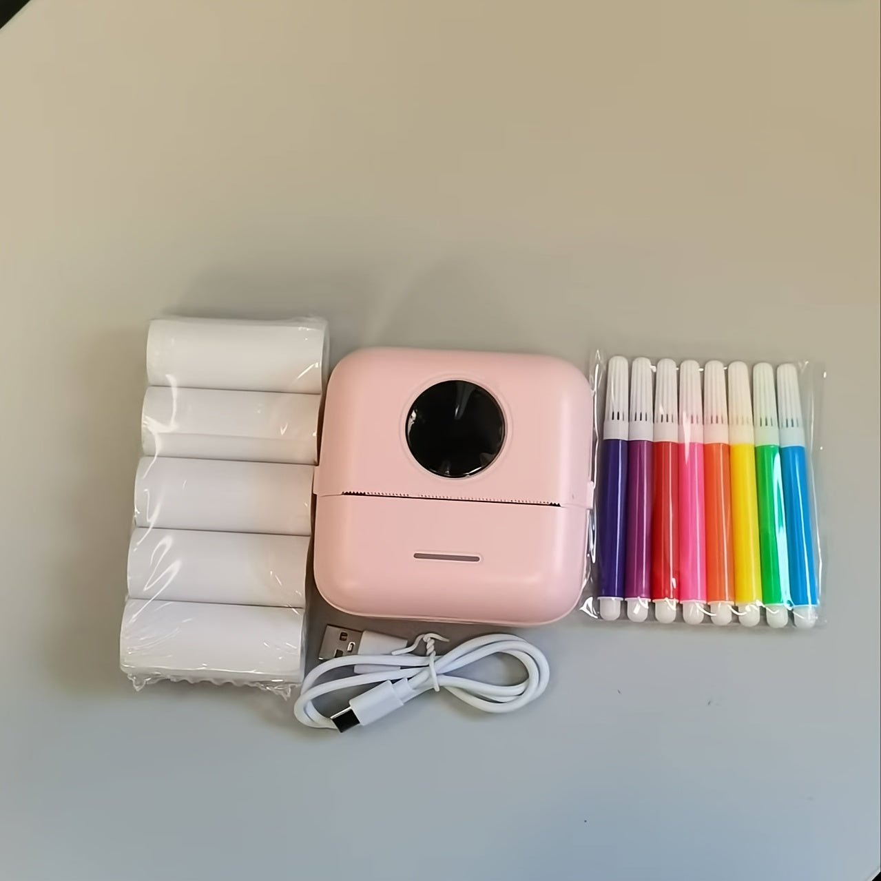 Mini thermal label printer with rechargeable battery for scrapbooking and diaries.