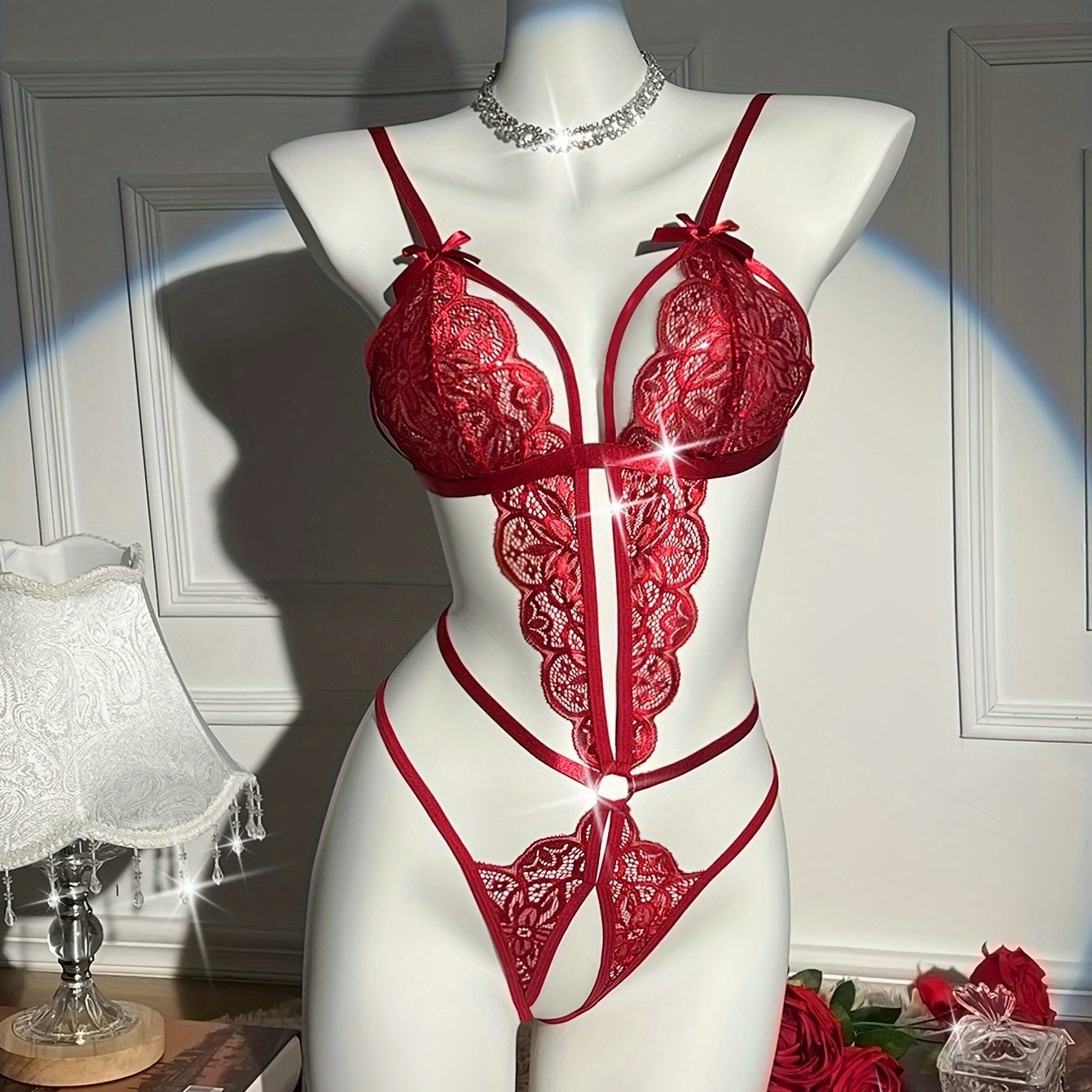 Sexy floral lace teddy bodysuit with open crotch design, bow detail, and medium support - 90% polyamide 10% elastane.