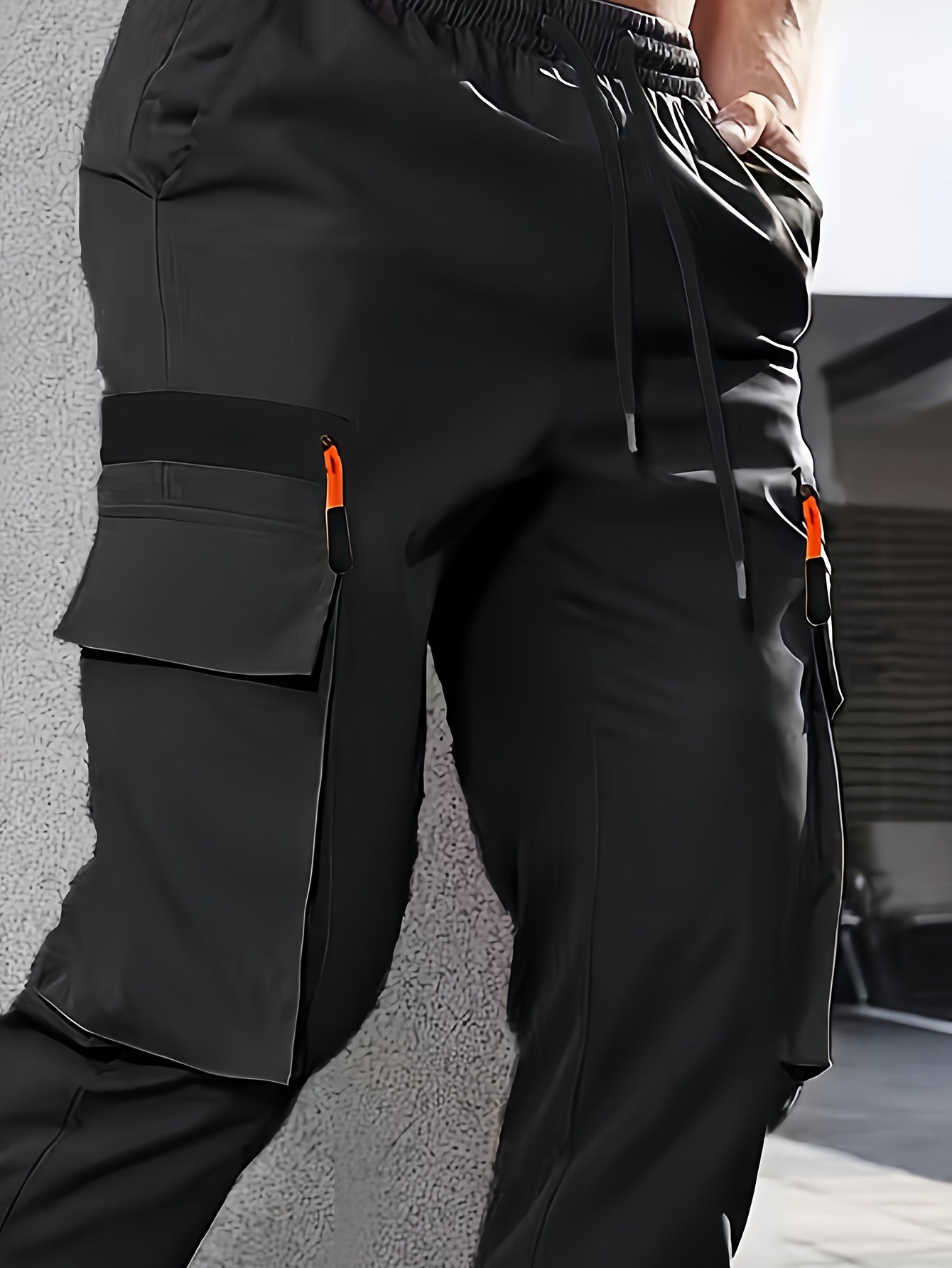 Men's casual cargo pants made of 100% polyester with an elastic waist, multi-pocket design, regular length, and loose fit for spring and fall wear.