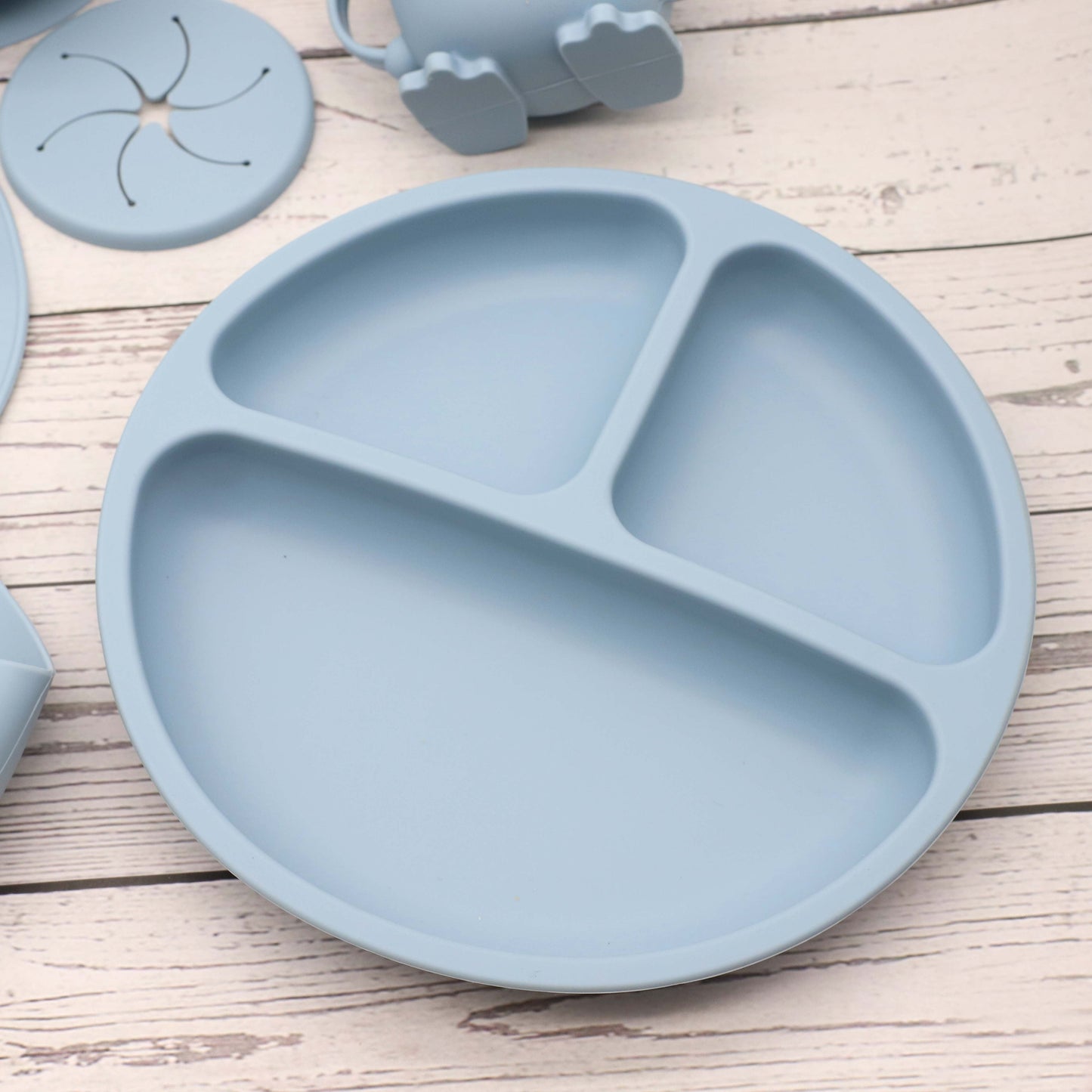 6 piece set of Silicone Feeding Items, featuring a Silicone Bib, Silicone Suction Plate, Silicone Suction Bowl, 2-in-1 Drinking Training Cup. Made of soft and safe, food-grade silicone that is BPA-free. Perfect Easter gift idea.