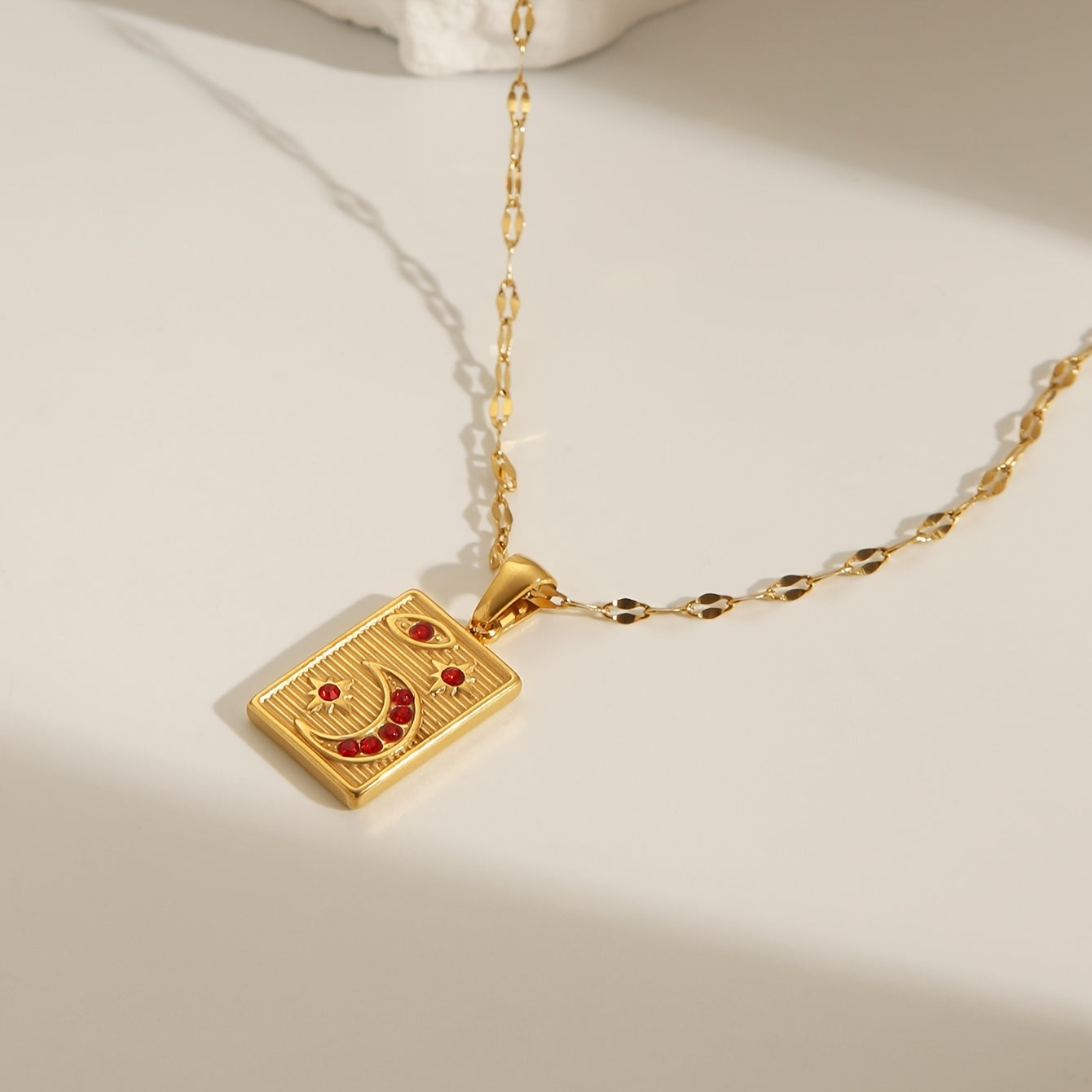 18K Golden Plated Stainless Steel Pendant Necklace featuring a Minimalistic Geometric Rectangle & Crescent Moon Design adorned with Red Synthetic Zirconia Stones, a Stylish and Versatile Piece of Fashion Jewelry perfect for Women to Wear on Both Daily