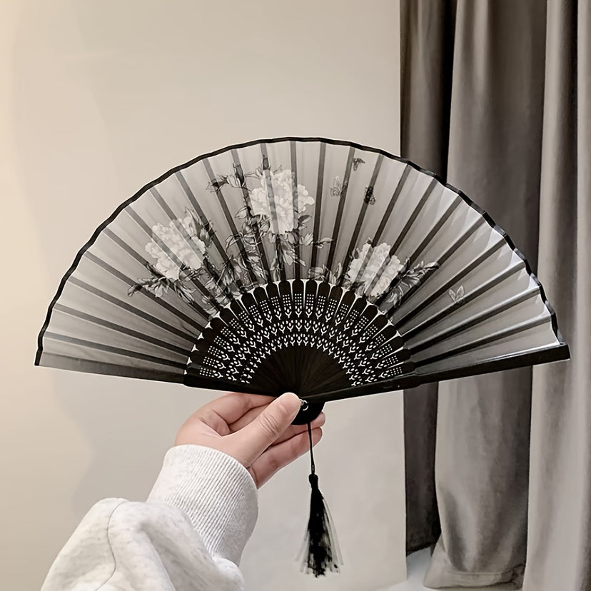 Asian-inspired bamboo hand fan with plant design - perfect for home decor, dance, or as a gift.