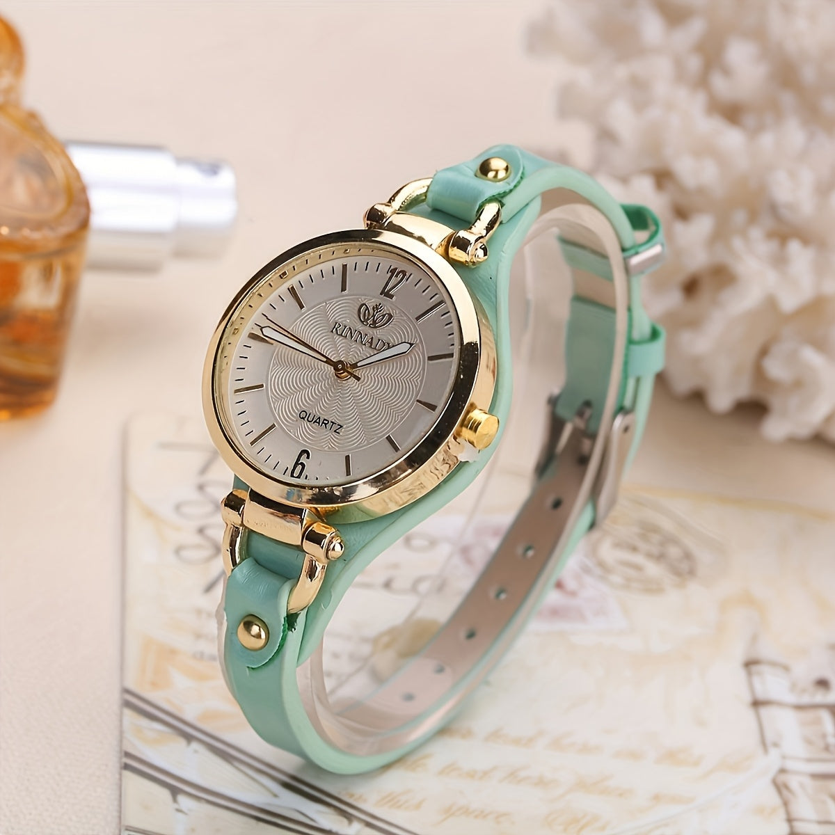 1 elegant women's quartz watch with black faux leather strap and golden-tone accents - fashionable analog display, battery operated, perfect for everyday and special occasions.