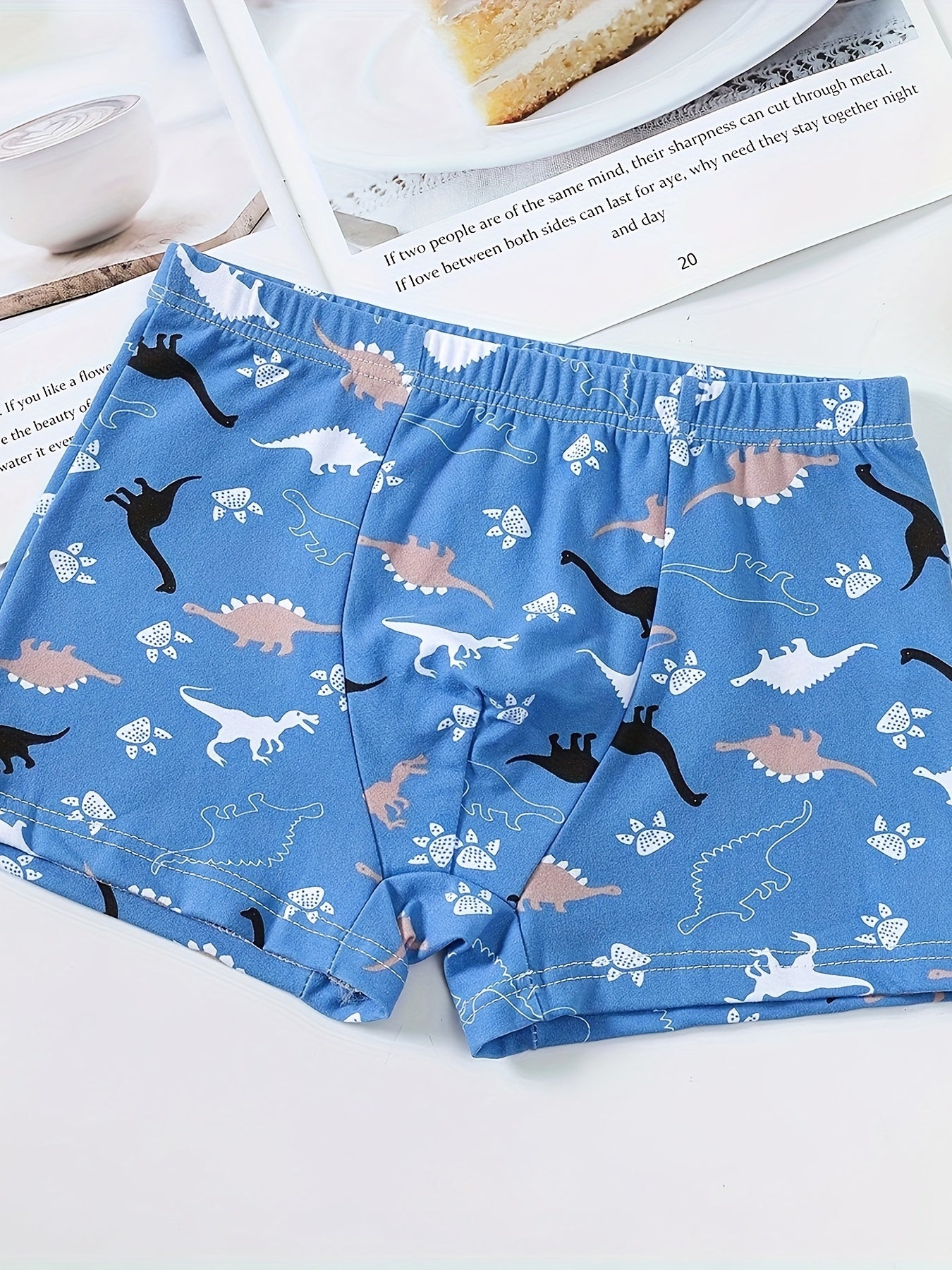 Boys' 3-pack soft cotton blend boxer briefs with cartoon dinosaur patterns. Comfortable and breathable for everyday wear. Casual style with elastic waistband.