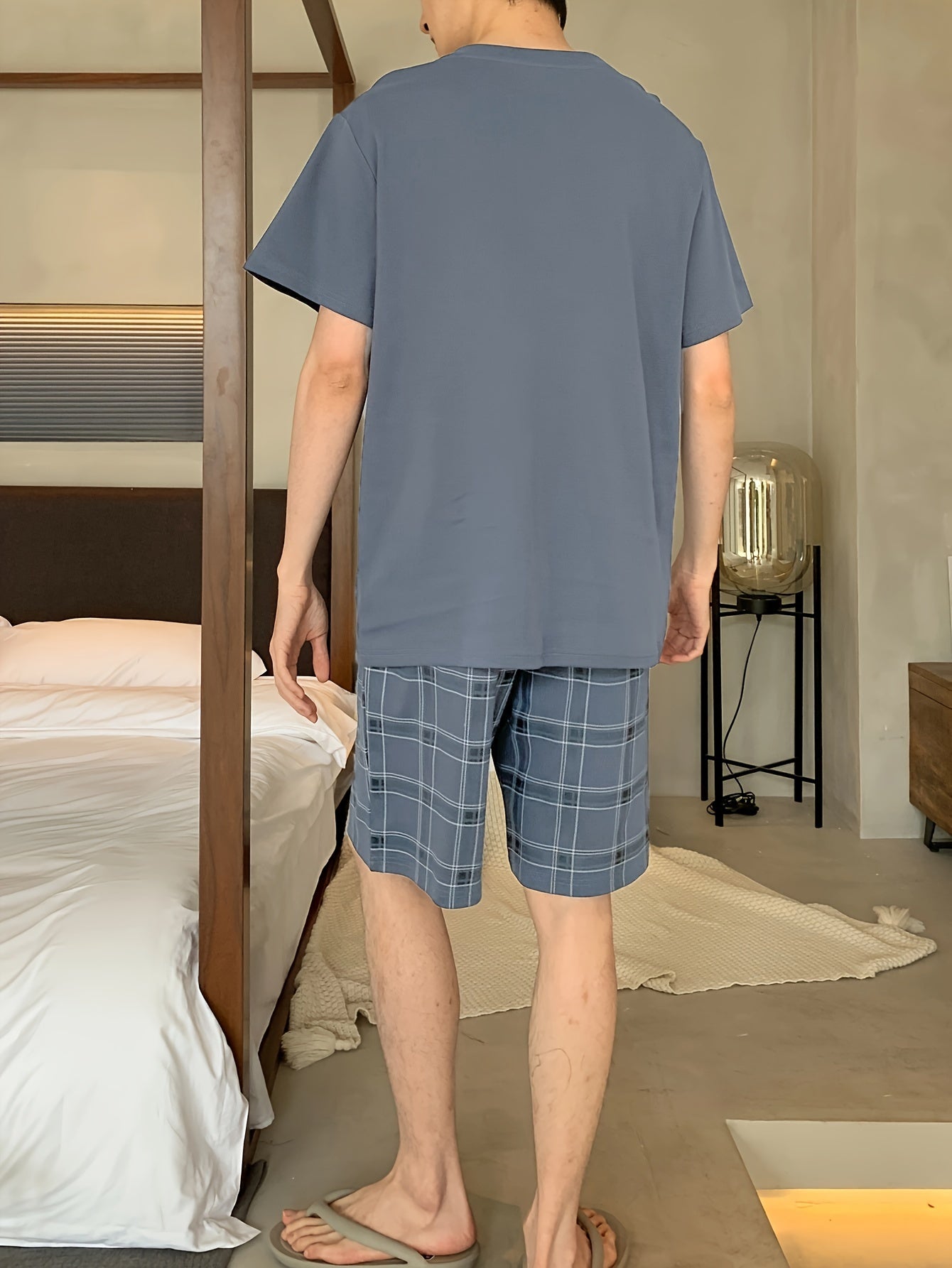 Men's stylish and comfortable 2-piece cotton pajama set with short sleeve top and shorts for lounging at home.