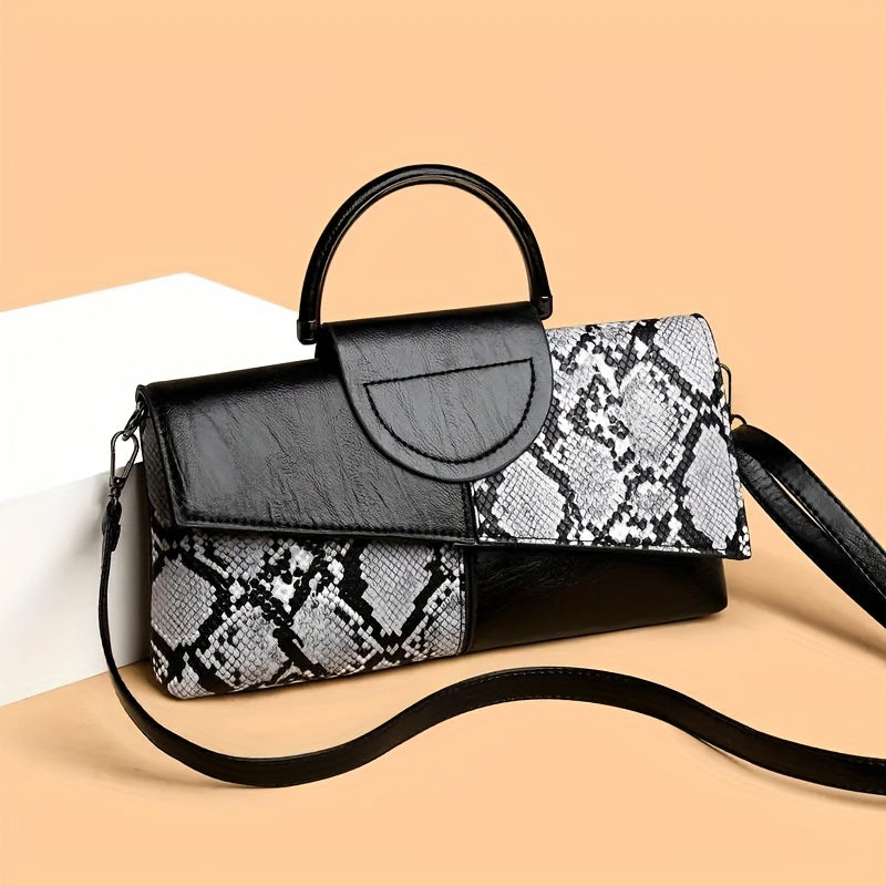 Elegant black and white snake skin design crossbody bag with adjustable strap for everyday use.