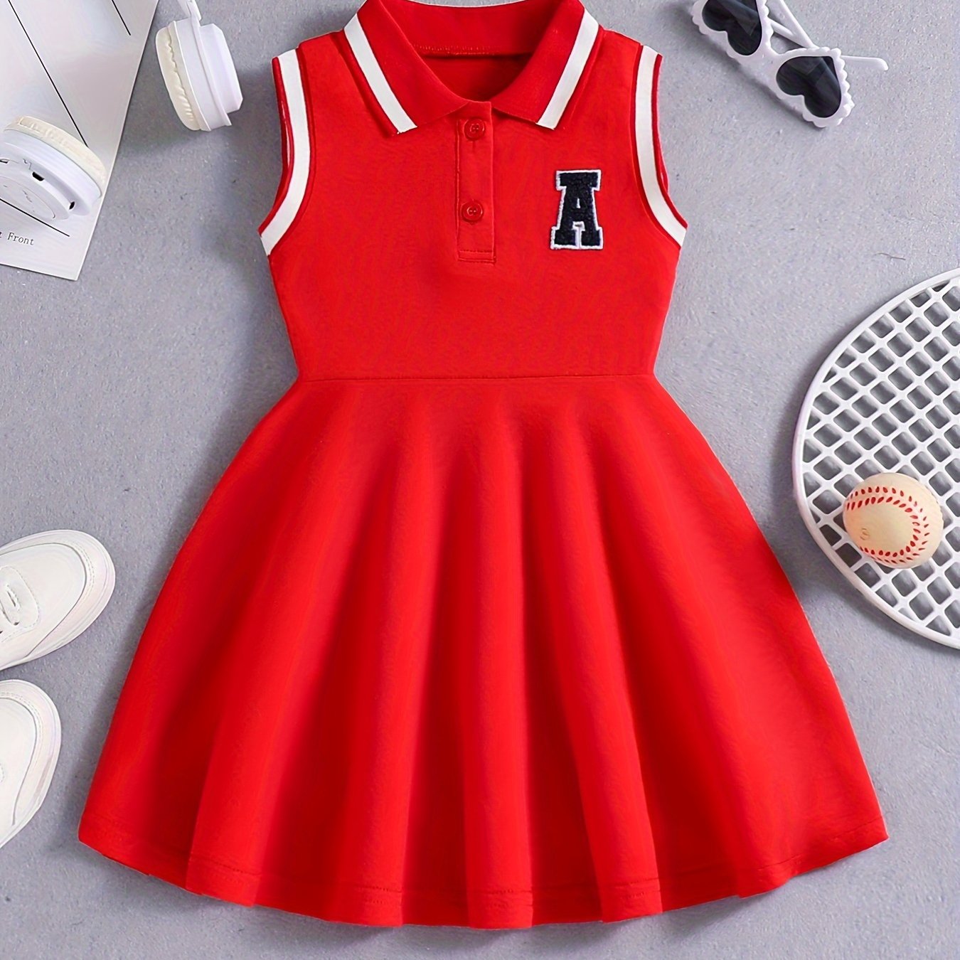 Girls' Red Tennis & Athletic Dress in sporty elegance featuring breathable, sweat-absorbent polyester with stretch and sleeveless design with black lettering for sports and casual wear.