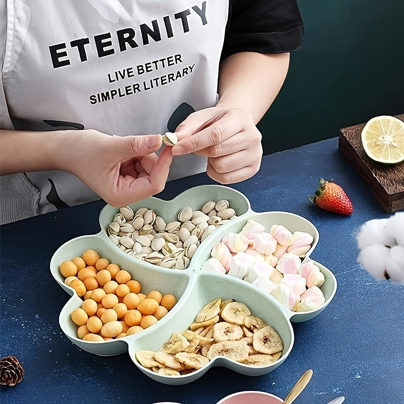 Heart-shaped party snack tray with 4 compartments, perfect for serving nuts, candy, fruit, and other snacks. Made of reusable plastic in blue, green, beige, and pink colors.