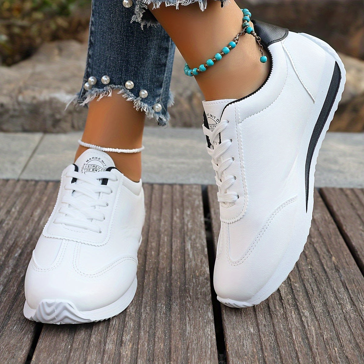 White synthetic leather women's casual sneakers with stability support, all-season comfort, and breathable fabric lining. Perfect for casual attire.