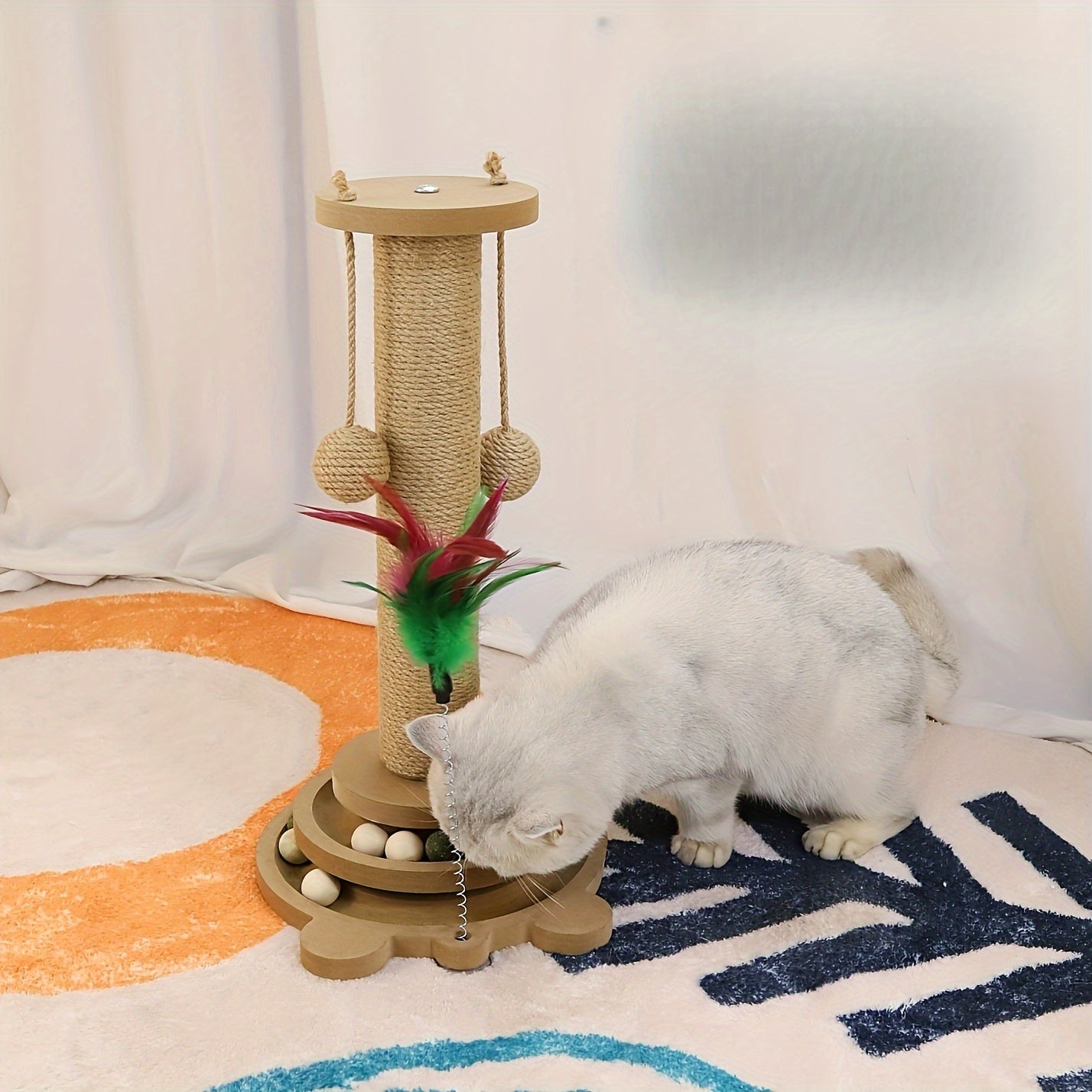 Sisal scratching post with rotating base and play balls for cats' claw care.