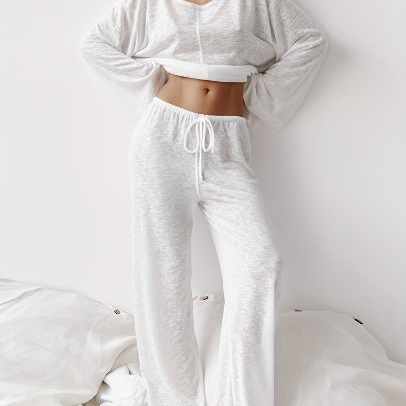 Two-piece set of loose home clothes for women made with micro-transparent fabric featuring a round neck, long sleeves, and trousers.