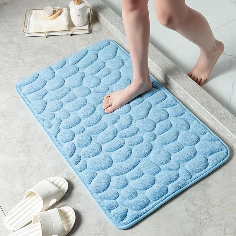 The Coral Fleece Non-Slip Bath Mat features a pebble design and is made of memory foam for ultimate comfort. This machine-washable bathroom rug has a solid pattern, flat woven construction, and low pile for easy care. It has a weight of 400gsm and comes