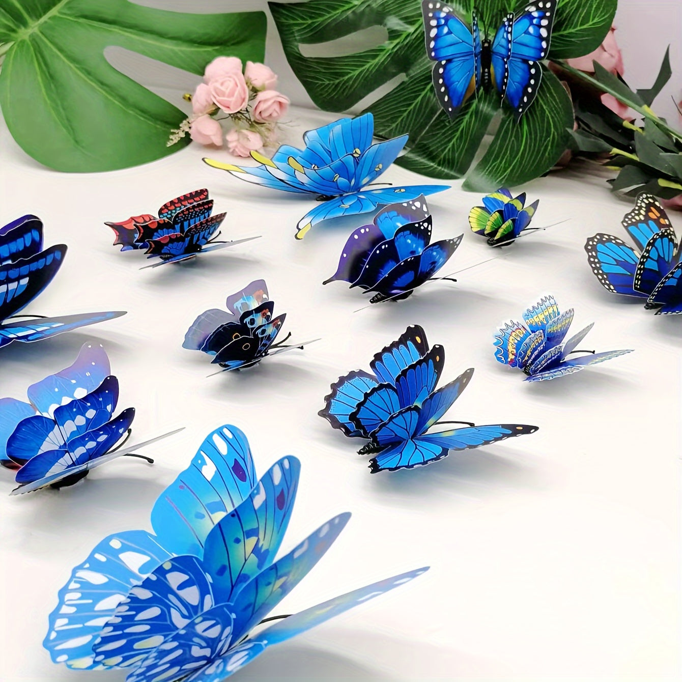 12pcs of vibrant 3D butterfly wall decals in blue shades, double-layer design, removable and self-adhesive stickers for home decor, parties, and weddings. Made of paper, these butterfly decorations are perfect for adding a touch of nature to your living