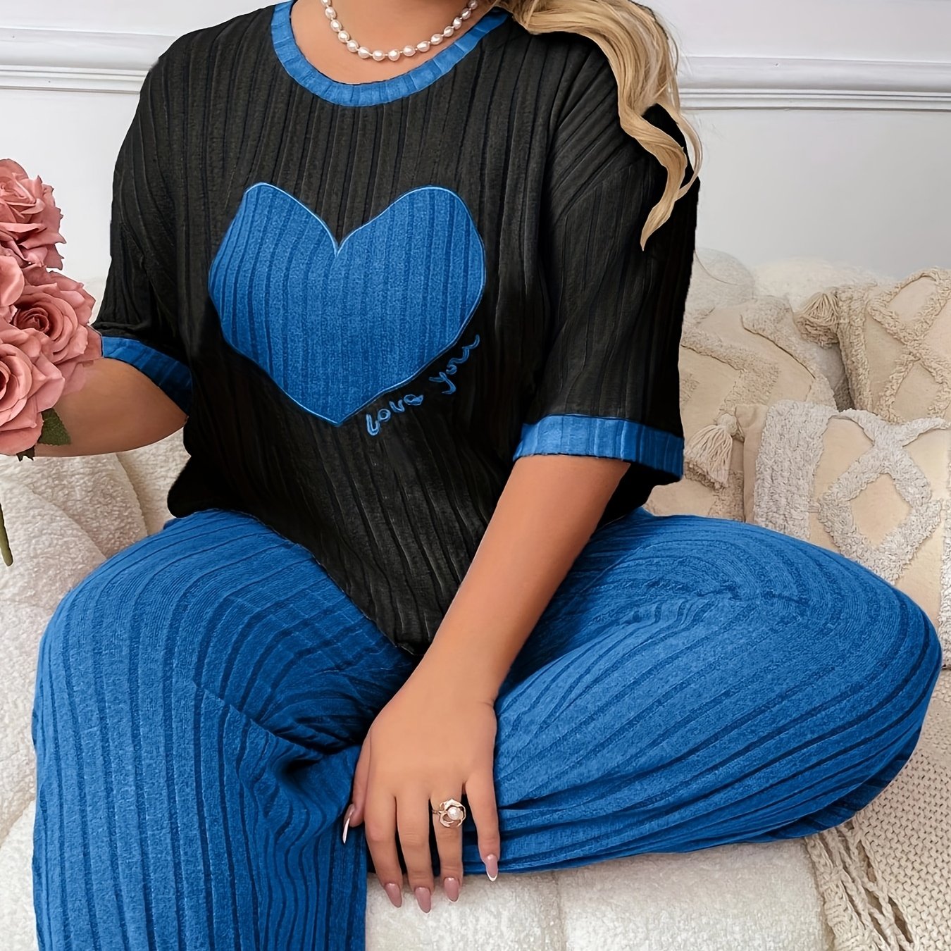 Cozy heart embroidered pajama set in plus size, includes short sleeve top and long pants made of soft polyester. Machine washable.