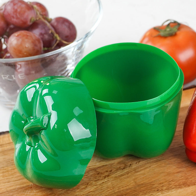 Food storage container in the shape of a green pepper, made of reusable and hand-washable plastic with a flip-top lid. Perfect for storing fresh veggies and other items in the kitchen. Can be used as a multifunctional organizer on the countertop.