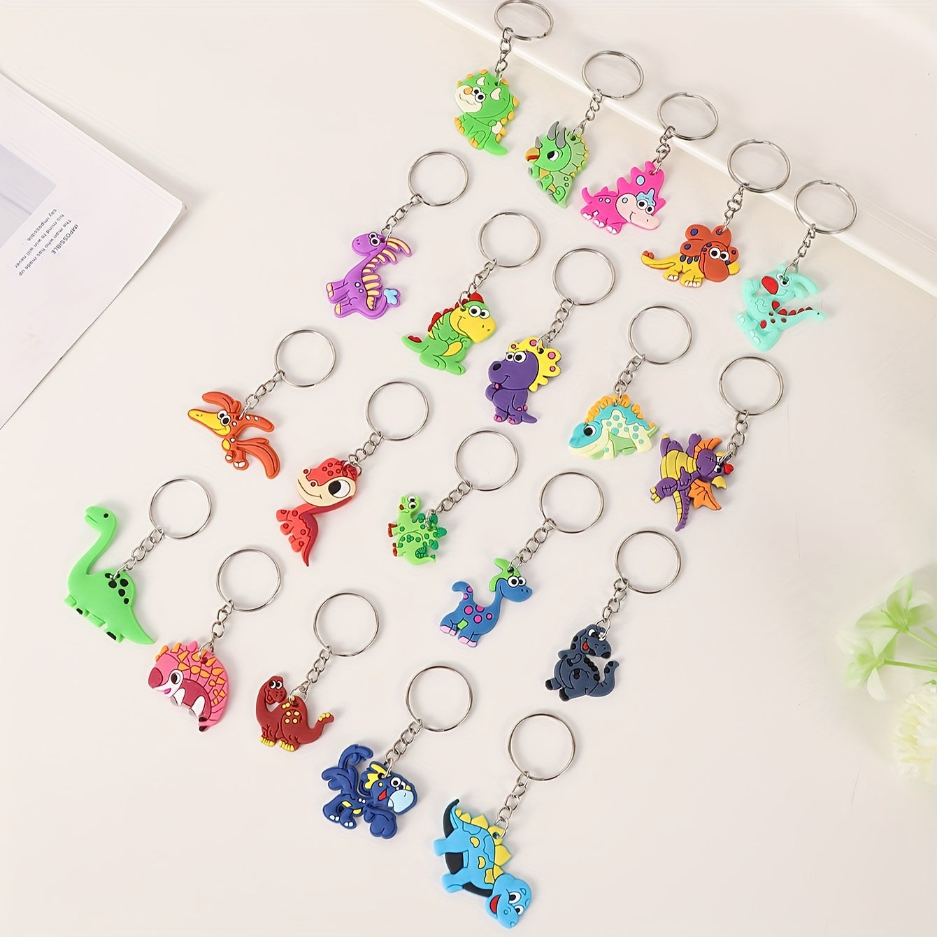 Set of 20 cartoon dinosaur keychains made of PVC, perfect for attaching to bags. These colorful dino keychains are great for both women and men to add a fun touch to their belongings.