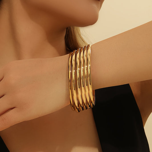 Set of 5 vintage-inspired slim bangles plated with 18K golden finish, perfect for stacking and accessorizing. Ideal for women, brides, parties, and gifts. Made from durable alloy for a versatile seasonal accessory.