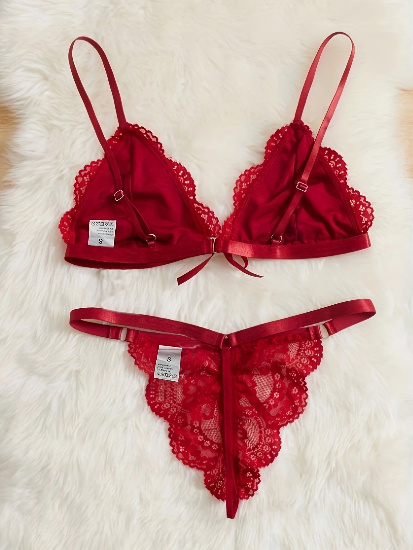 A women's lace lingerie set with a hollow design, open-crotch style, sexy bow detail, non-transparent bra, triangle cup shape, and Y2K style.