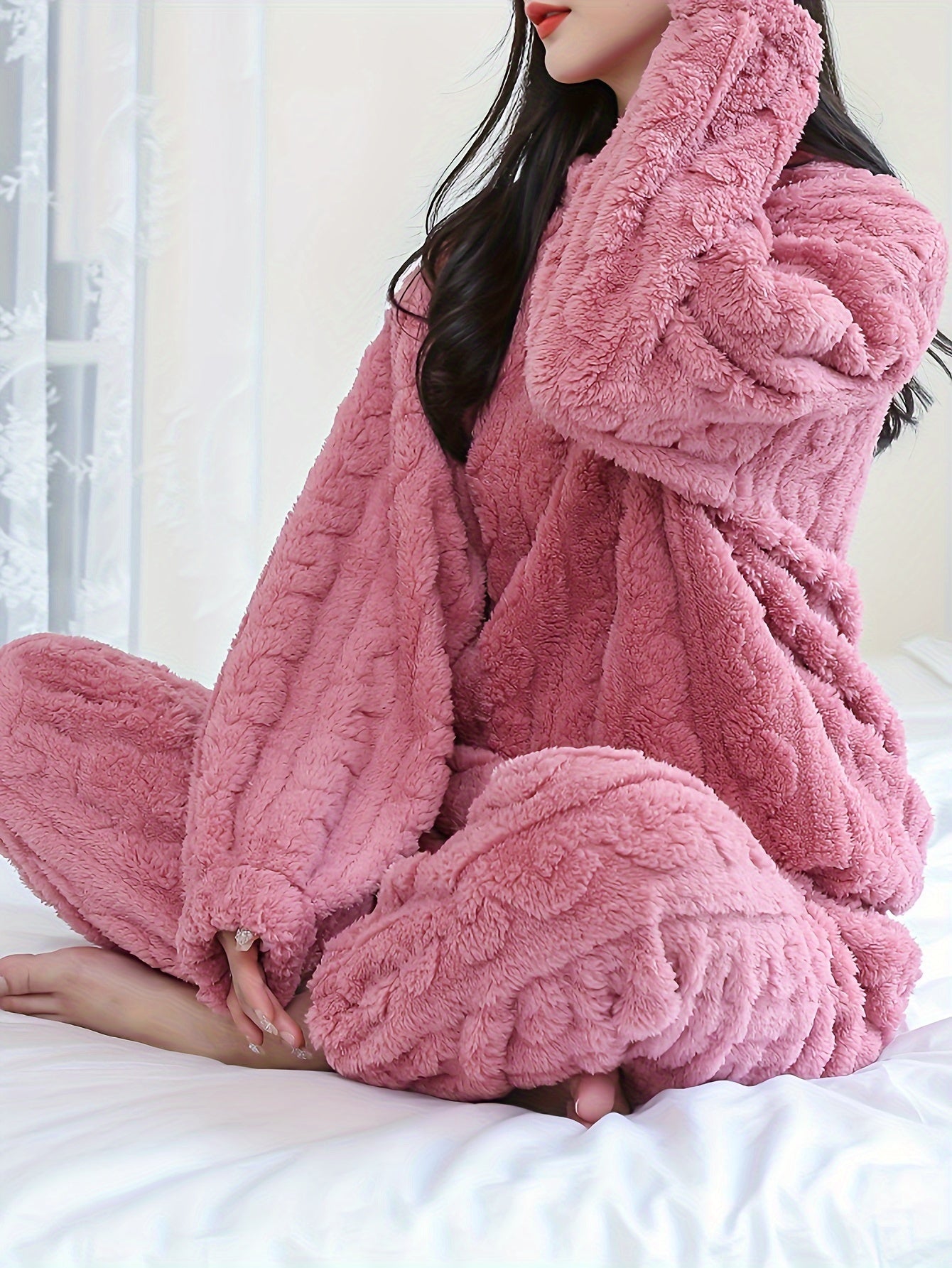 Soft pink fleece pajama set for women, long sleeves, round neck, warm and cozy for fall/winter, easy care machine washable.