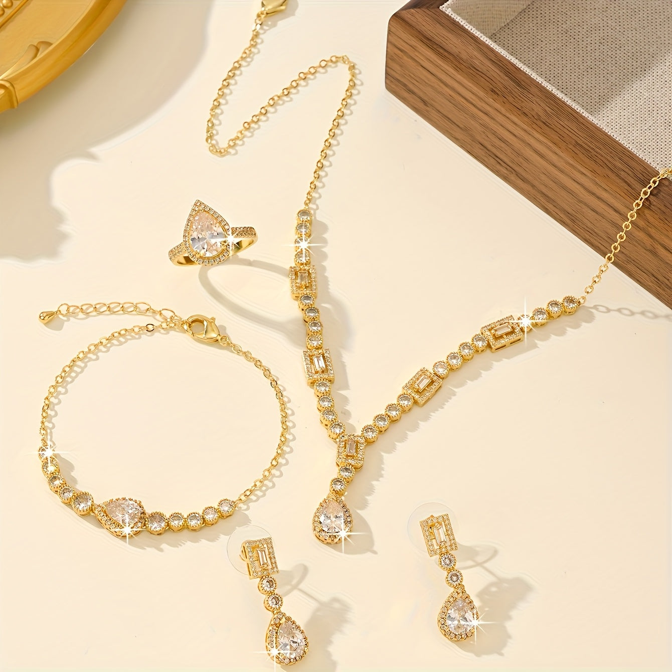 Luxury Jewelry Set Featuring 5 Pieces, Crafted from 18K Golden Plated Copper with Synthetic Cubic Zirconia Stones in a Geometric Teardrop Design. Includes Necklace, Earrings, Ring, and Bracelet, Perfect for Both Daily Wear and Wedding Occasions.