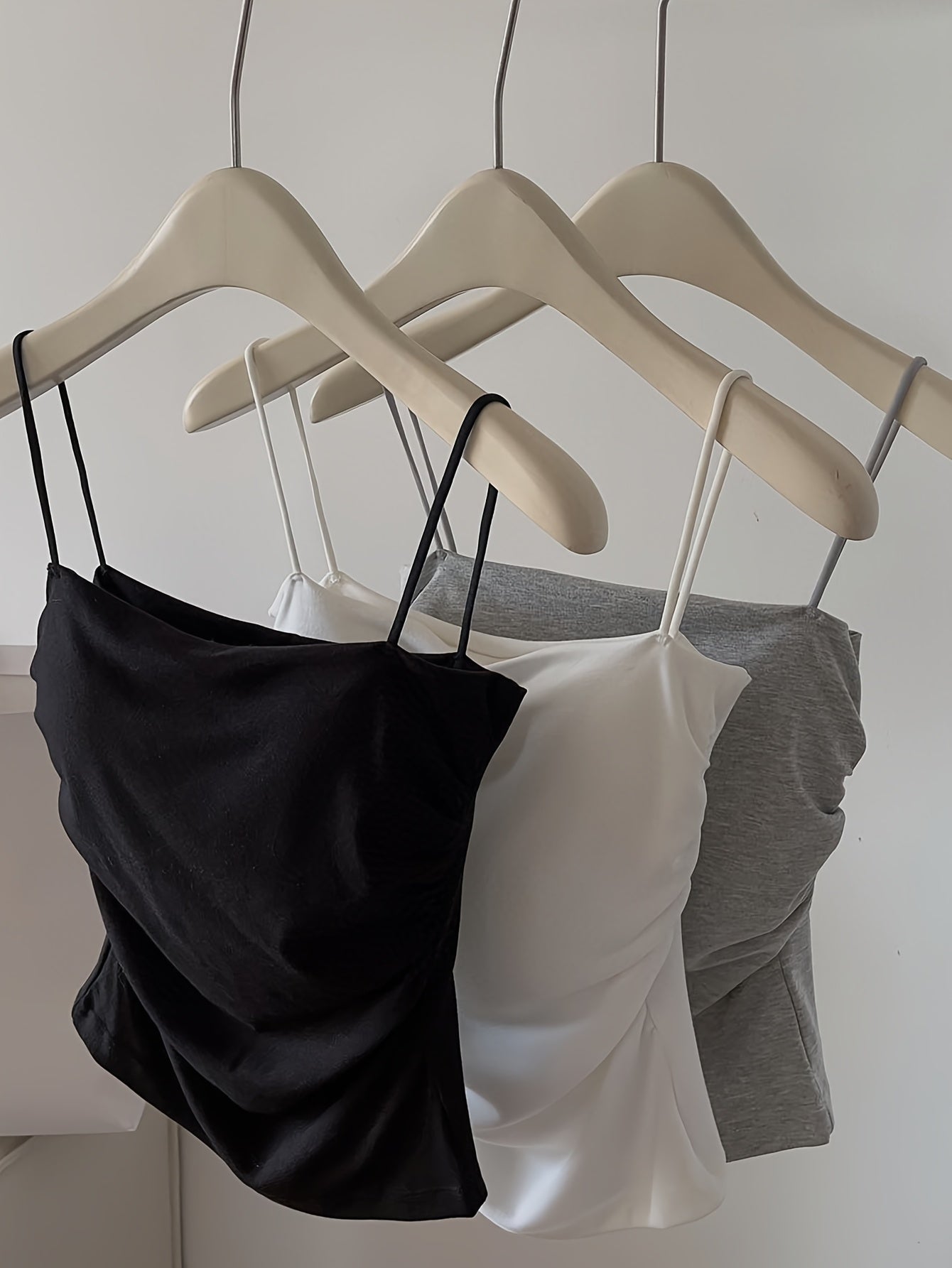 Four sexy ruffled camisoles for women with thin straps and a beautiful back, ideal for layering in summer with built-in padding.