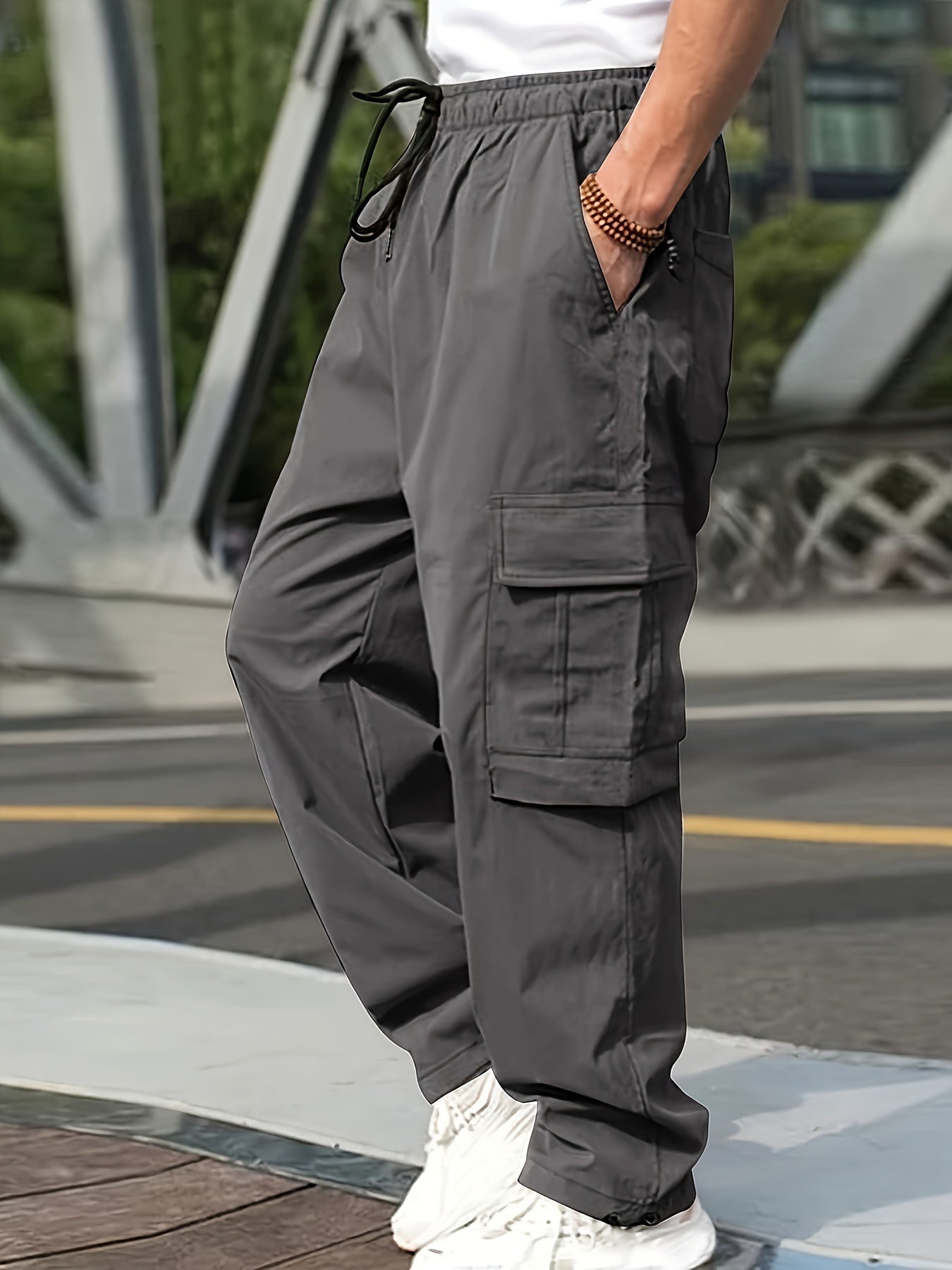 Men's cargo pants for outdoor activities with multiple pockets and drawstring waist.