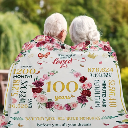 A beautiful Floral Centenarian Celebration Blanket - the perfect 100th Birthday present for beloved elderly women, mothers, and grandmothers. This all-season comfort blanket is machine washable and versatile, serving as a cozy fleece throw with a lovely