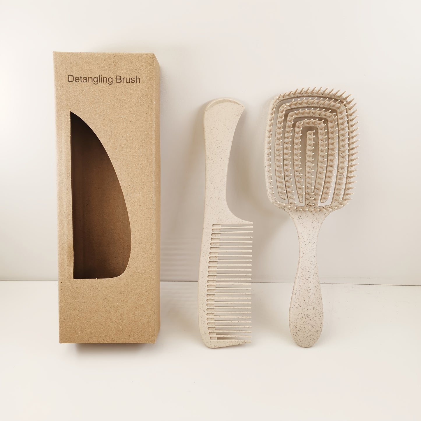 Detangling brush which comes with a large teeth comb, pressure massage hairbrush and can be used for both wet and dry hair. Made with ABS plastic handle and comes in a boxed set.