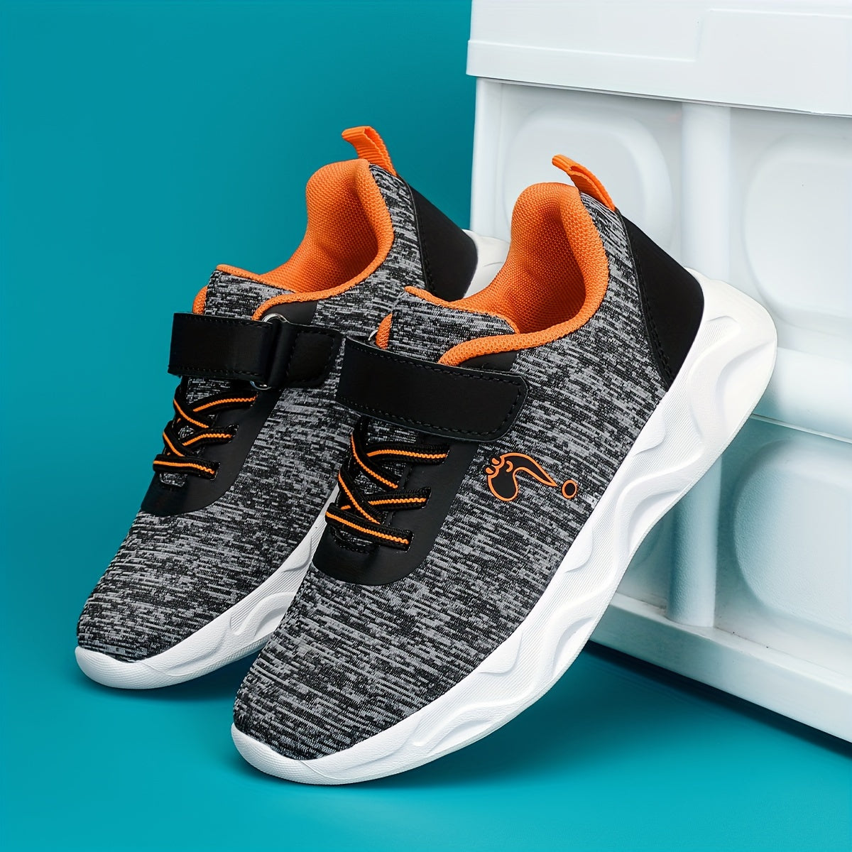 Breathable sneakers for kids with non-slip soles and hook and loop closure.