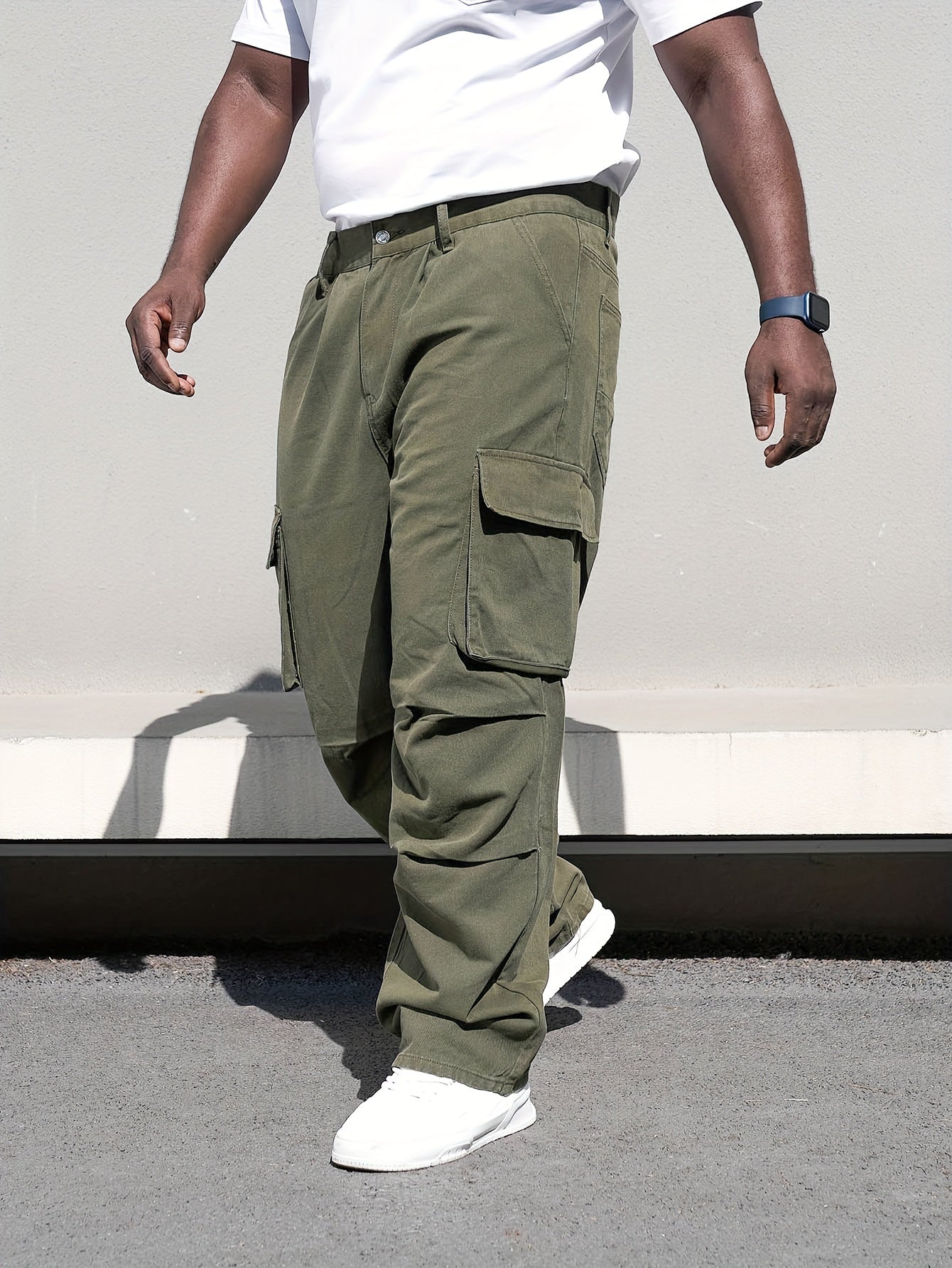 Men's plus size casual denim trousers with loose fit, cotton cargo pants featuring multiple pockets for a trendy look.