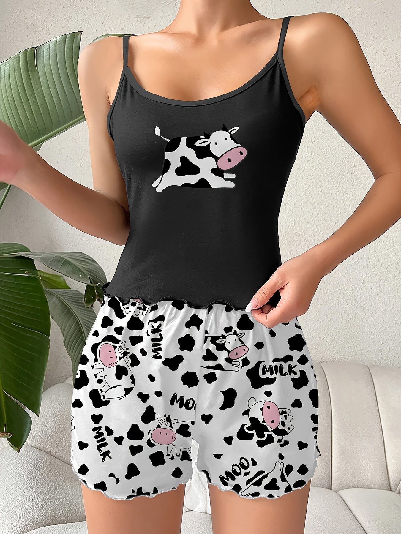 Cow print lounge set including a backless cami top and elastic shorts for women.