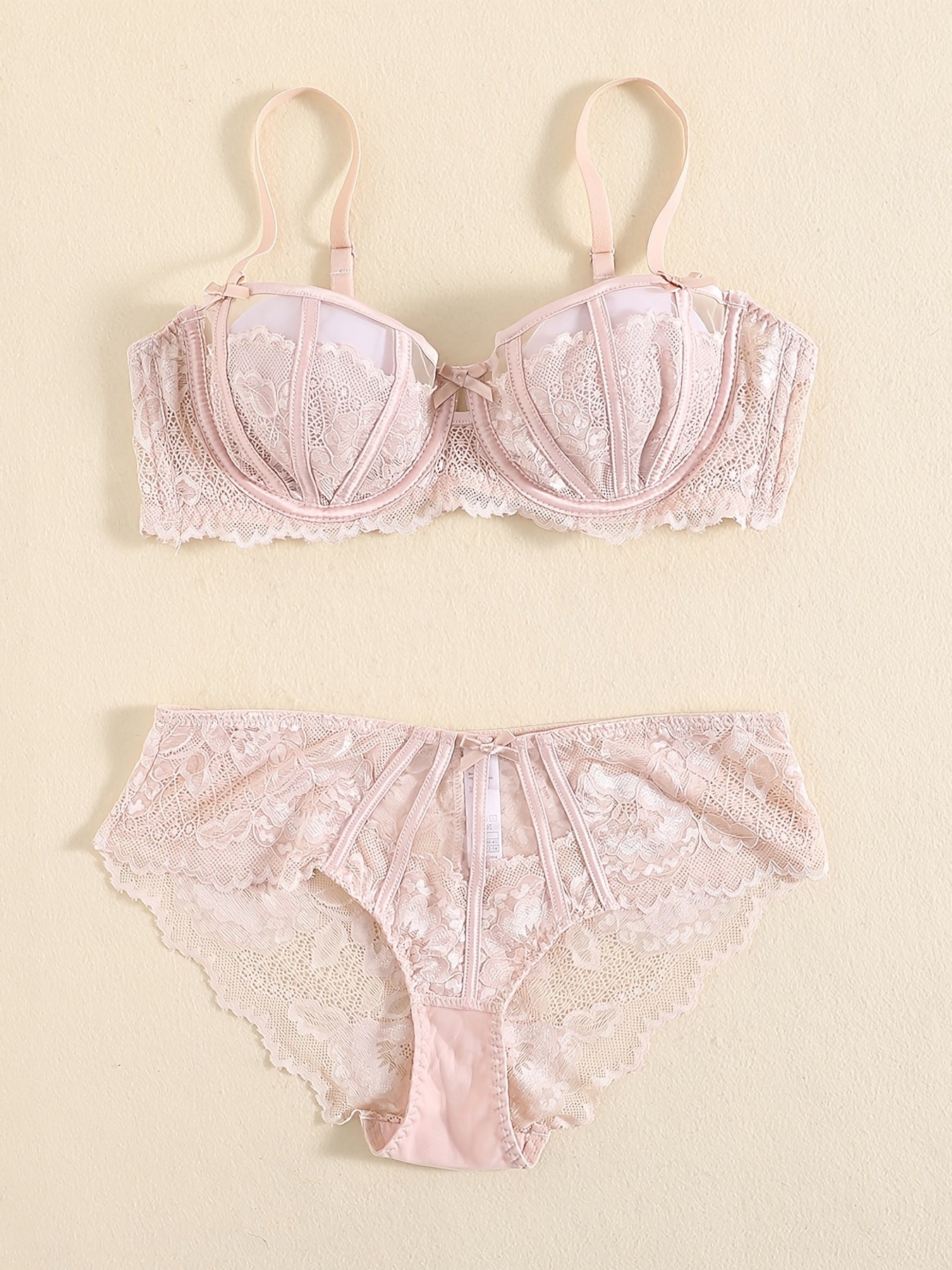 Floral lace unlined bra and bow panties set for women.