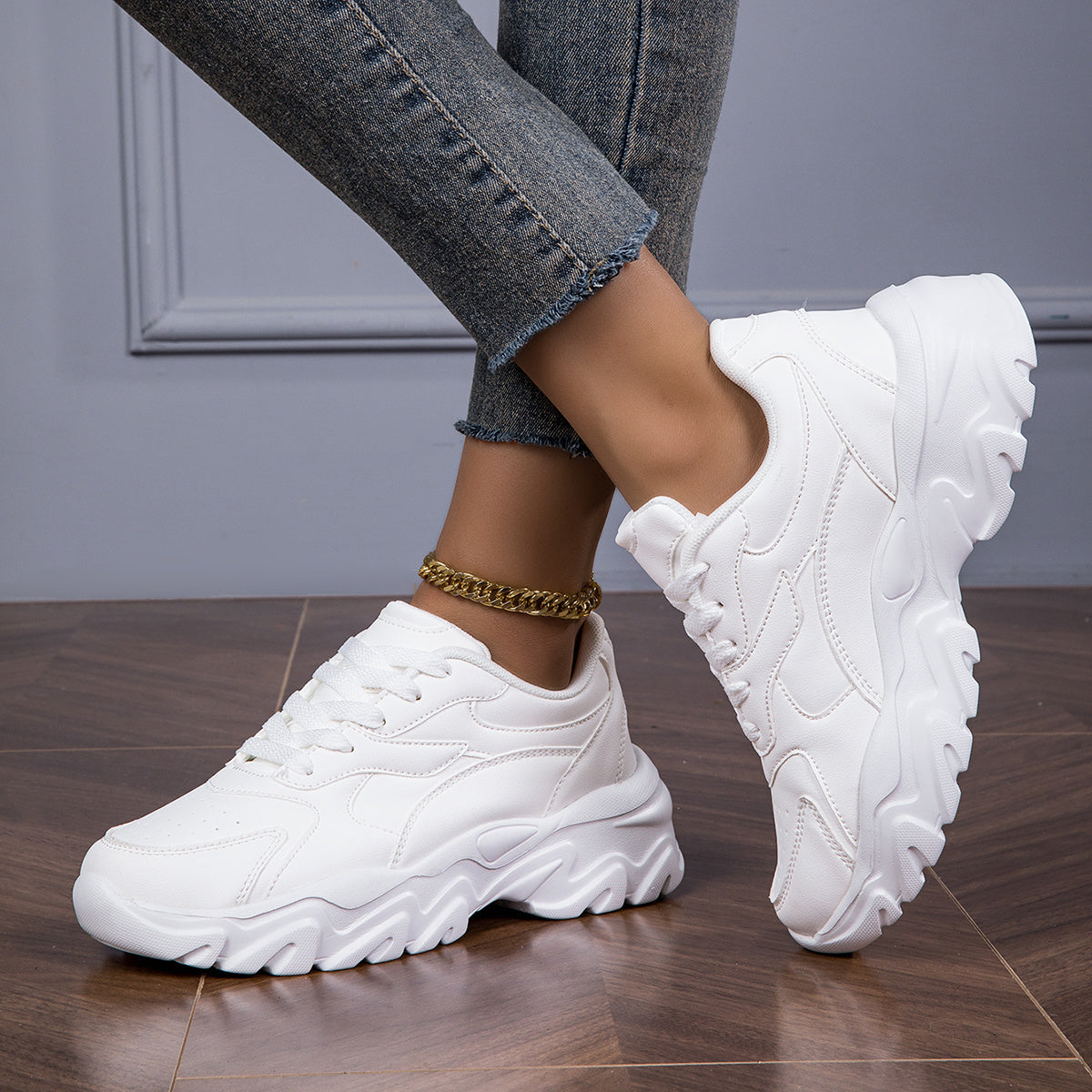 Women's white low-top lace-up sneakers for casual walks and shopping.